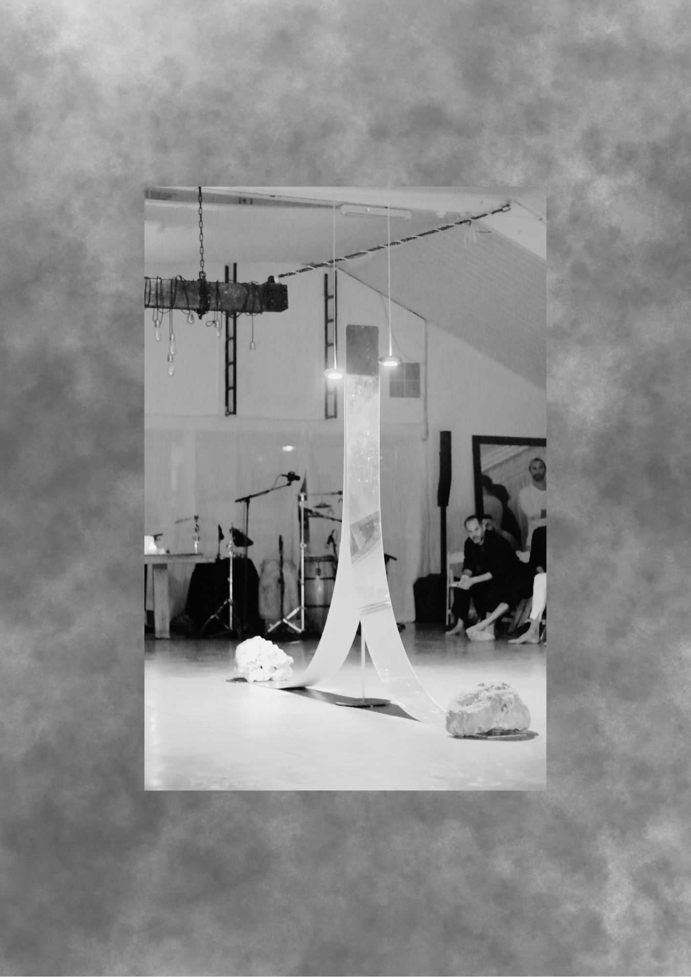 Minimal installation with hanging translucent material in a bright room.