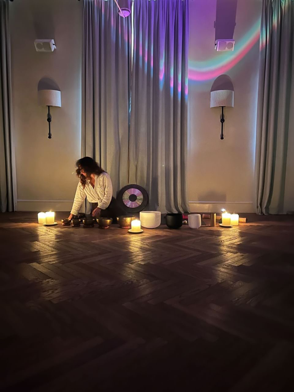 Candlelit room prepared for a sound ceremony.